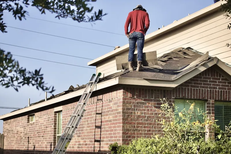 Professional roofer working on a residential roof in Big Rapids
